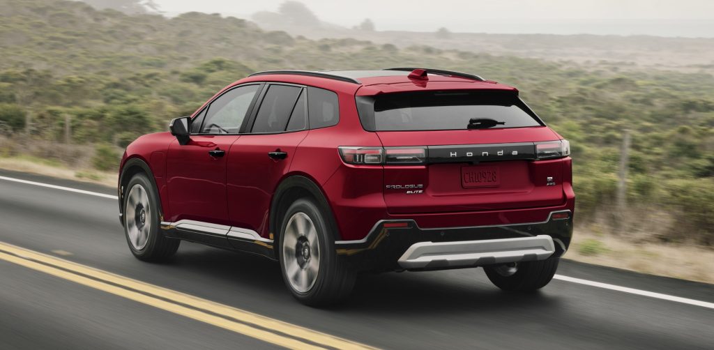 2024 Honda Prologue Elite rear side view driving on a road.