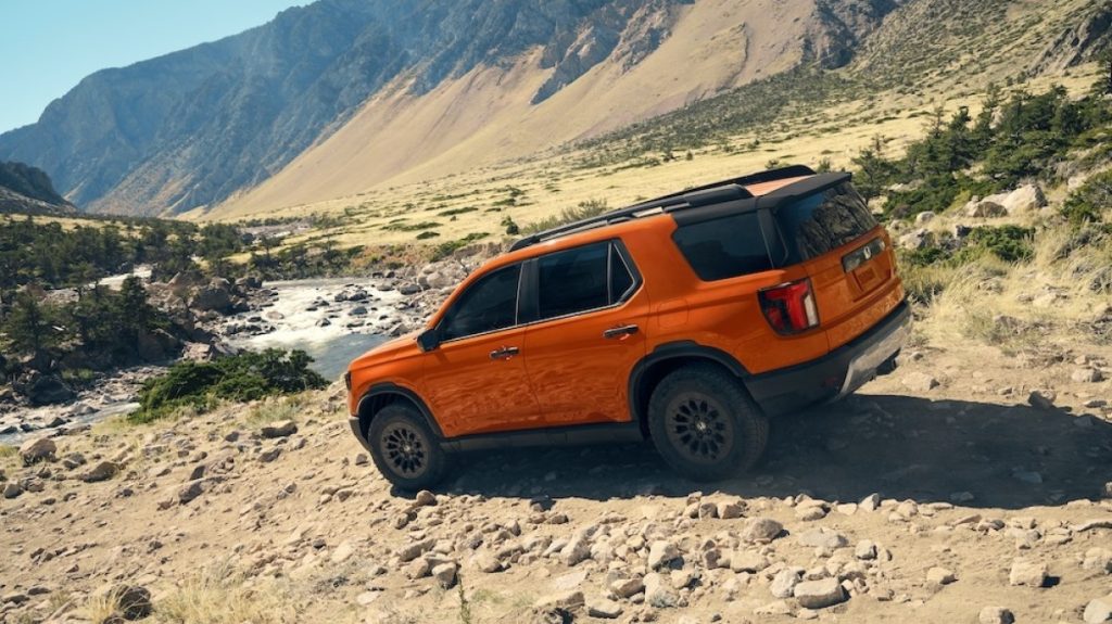 Rear side view of a 2026 Honda Passport Trailsport parked off-road.