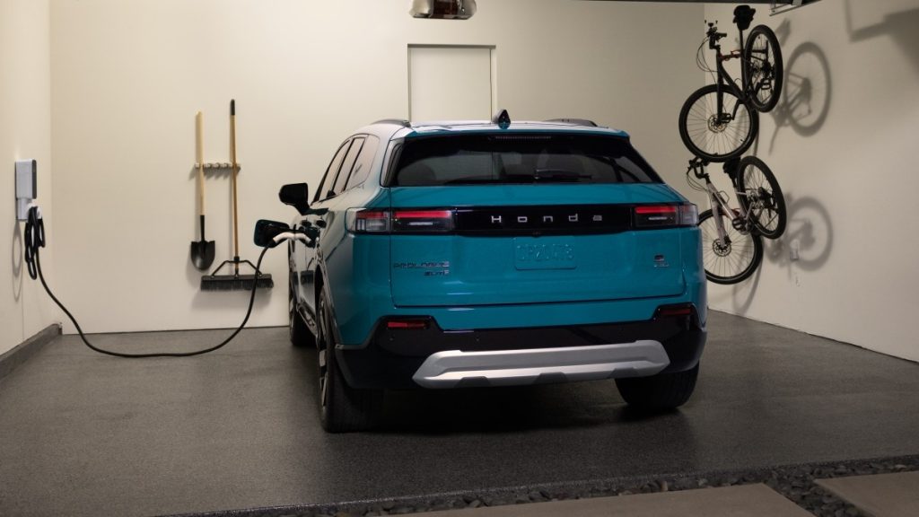 2024 Honda Prologue Elite parked in a garage plugged into a charger