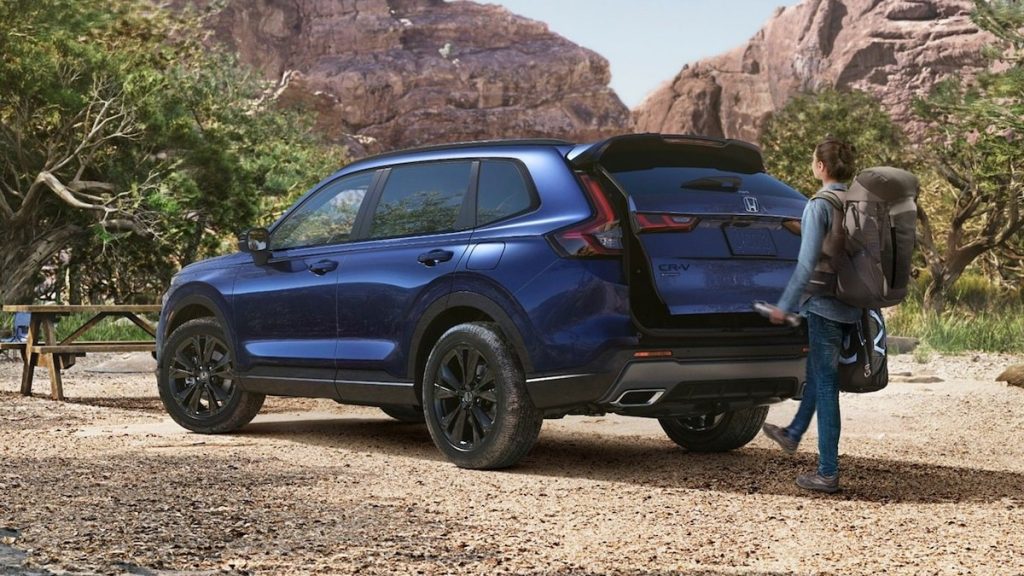 2026 Honda CR-V Sport Touring Hybrid shown in Canyon River Blue Metallic. Hands-free access power tailgate standard on Sport Touring Hybrid.