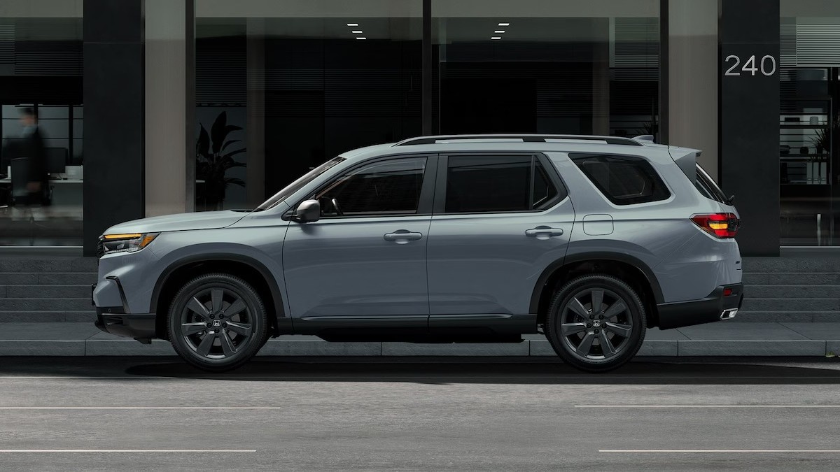 2025 Honda Pilot Sport shown in Sonic Gray Pearl side view parked on a city street