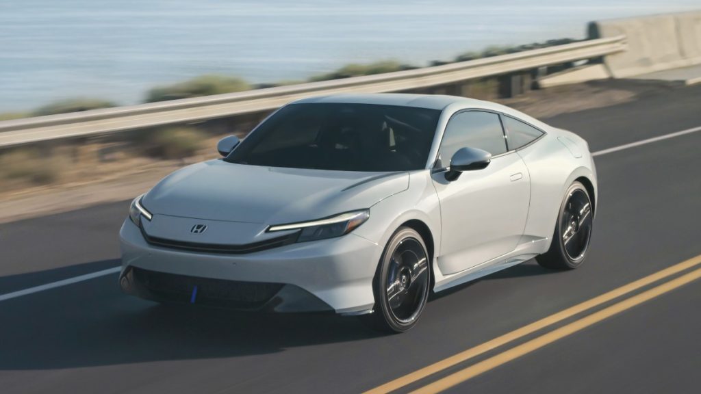 White 2026 Honda Prelude Hybrid driving next to the ocean
