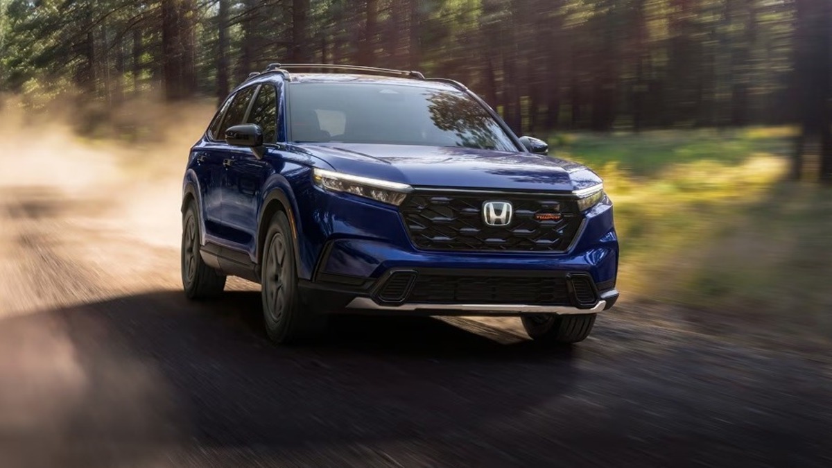 Blue 2026 Honda CR-V driving on a dirt road